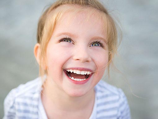 child at the dentist office learning about teeth